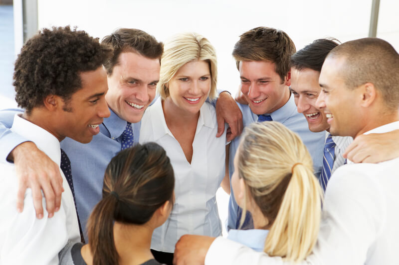 Close Up Of Business People Congratulating One Another In Team Building Exercise