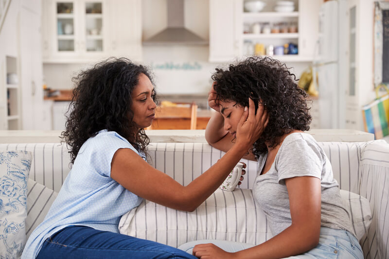 Mother talking to stressed daughter