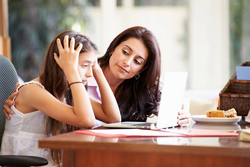 Mother helping stressed daughter